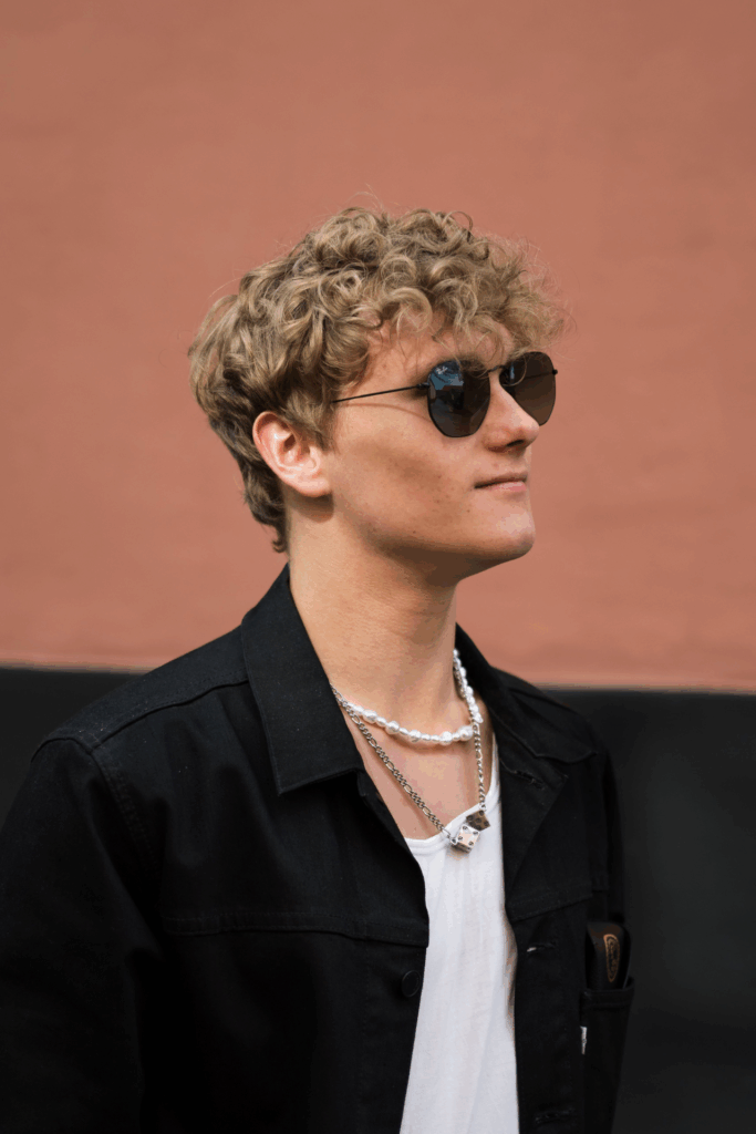 Ray-Ban-Designs: Junger Mann hat Sonnenbrille auf